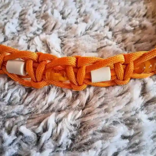 collier EM et ambre antipuces et tiques pour chiens et chats, le détail des perles et du tressage, coloris orange